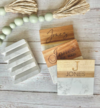 Wooden nameplates with engraved text on a wooden surface