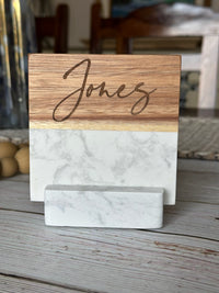 Wooden and marble nameplate with 'Jones' engraved on a wooden surface.