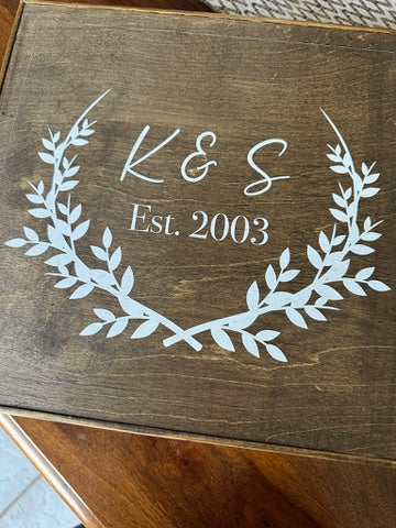 Wooden box with 'K & S Est. 2003' engraving on a wooden surface