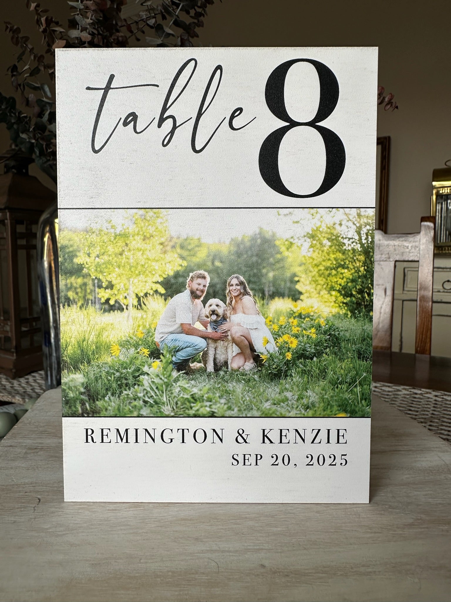 Table number with photo of couple and dog in a garden setting